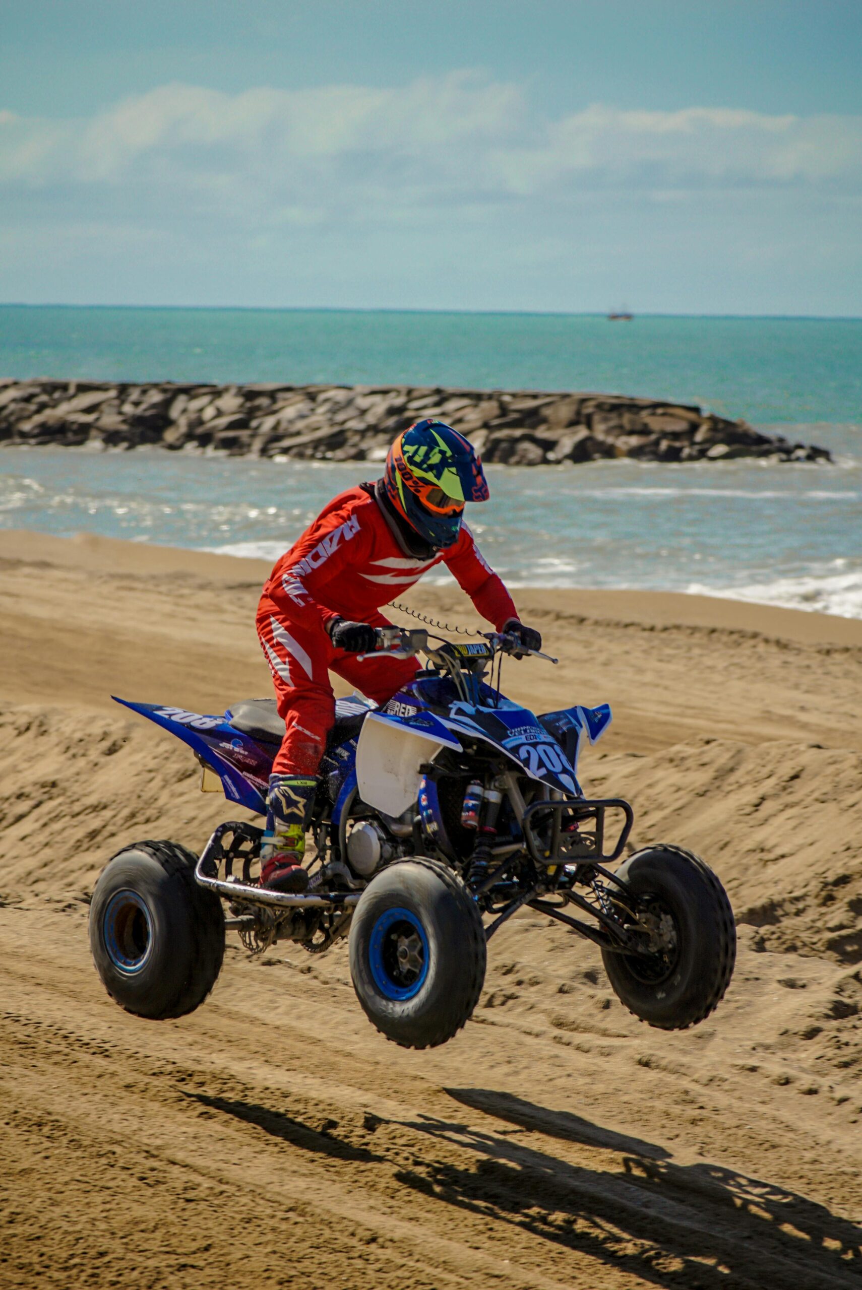 pexels-photo-18158113-18158113 A thrilling quad bike ride on a sandy beach showcasing motorsport and adventure.